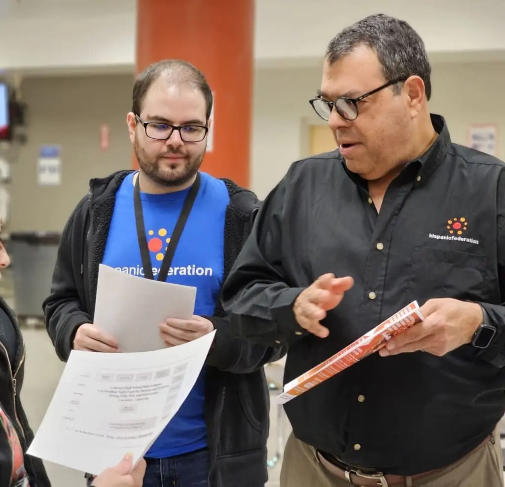 Senior leader talking to community member about voter registration